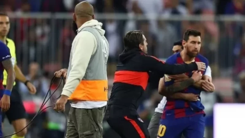 Photo: Fan Storms Field and Embraces Messi