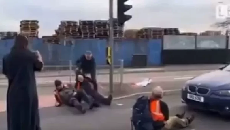 Video: Outraged Driver Tows Activists Blocking Road in Britain