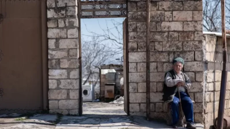 PHOTO: The Elder from Kharamort Sitting in Front of His House, and Who Controls the Village